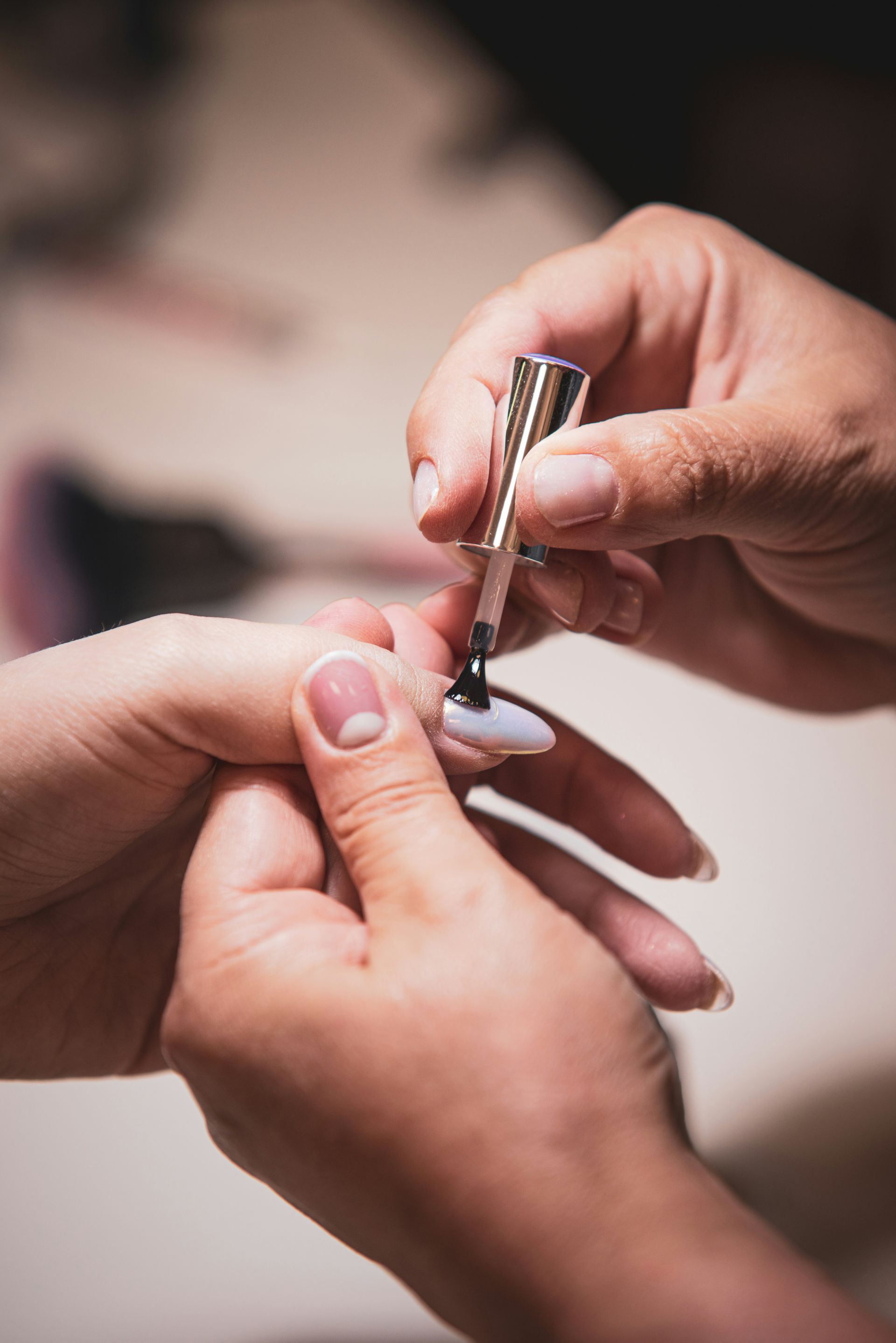 Someone is applying nail polish to a fingernail